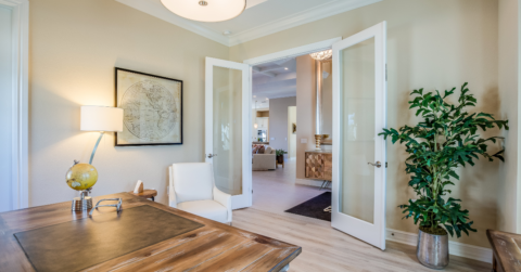 Photo of well lit and staged home office with french doors