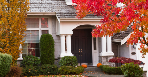 photo of entrance of home with bright red fall foliage