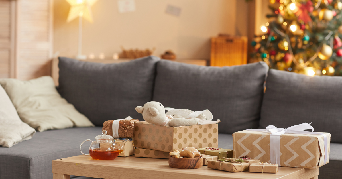 presents near a couch and christmas tree