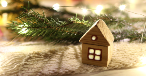 tiny house by lights and a tree