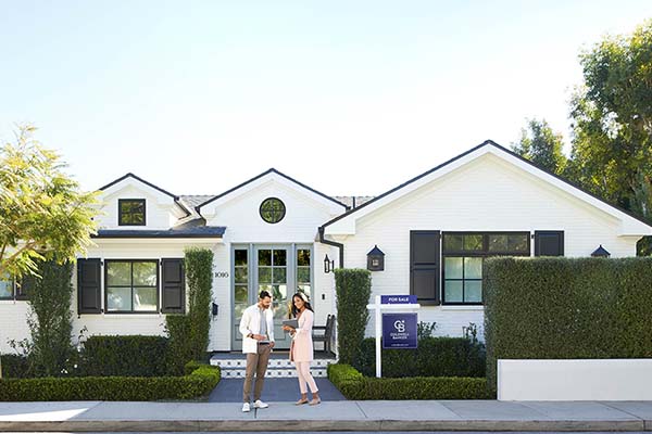 couple purchasing a beautiful white modern home