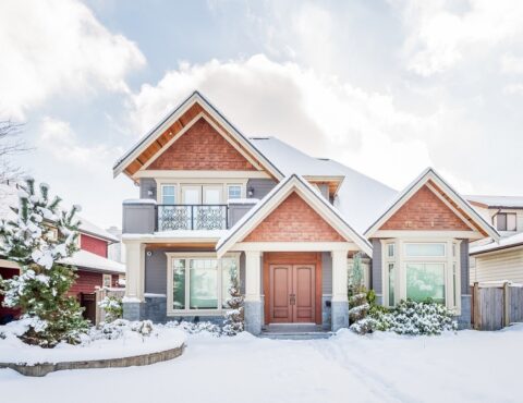 exterior of luxury home covered in snow