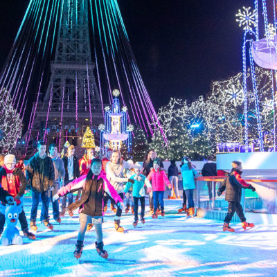 people ice skating under bright lights