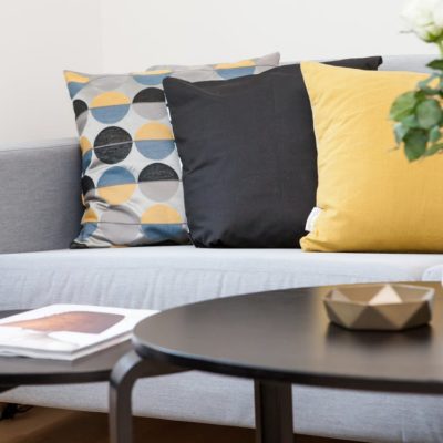 sofa with yellow and black accent pillows