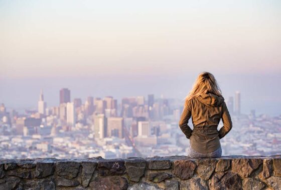 Lady standing overlooking San Francisco
