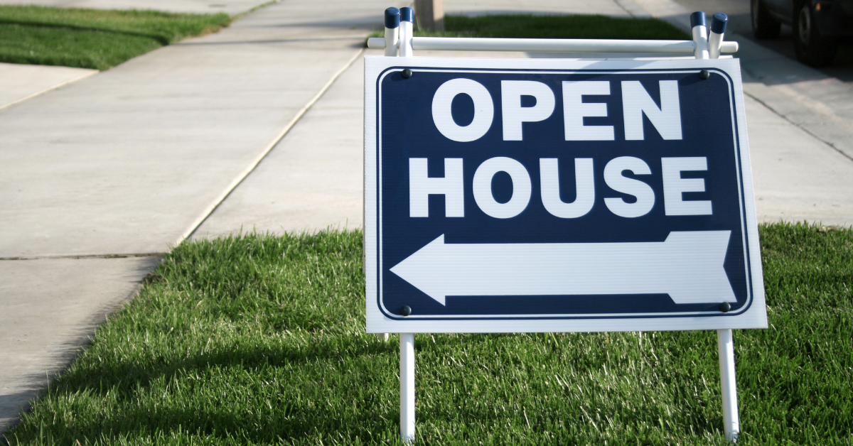 blue open house sign in yard